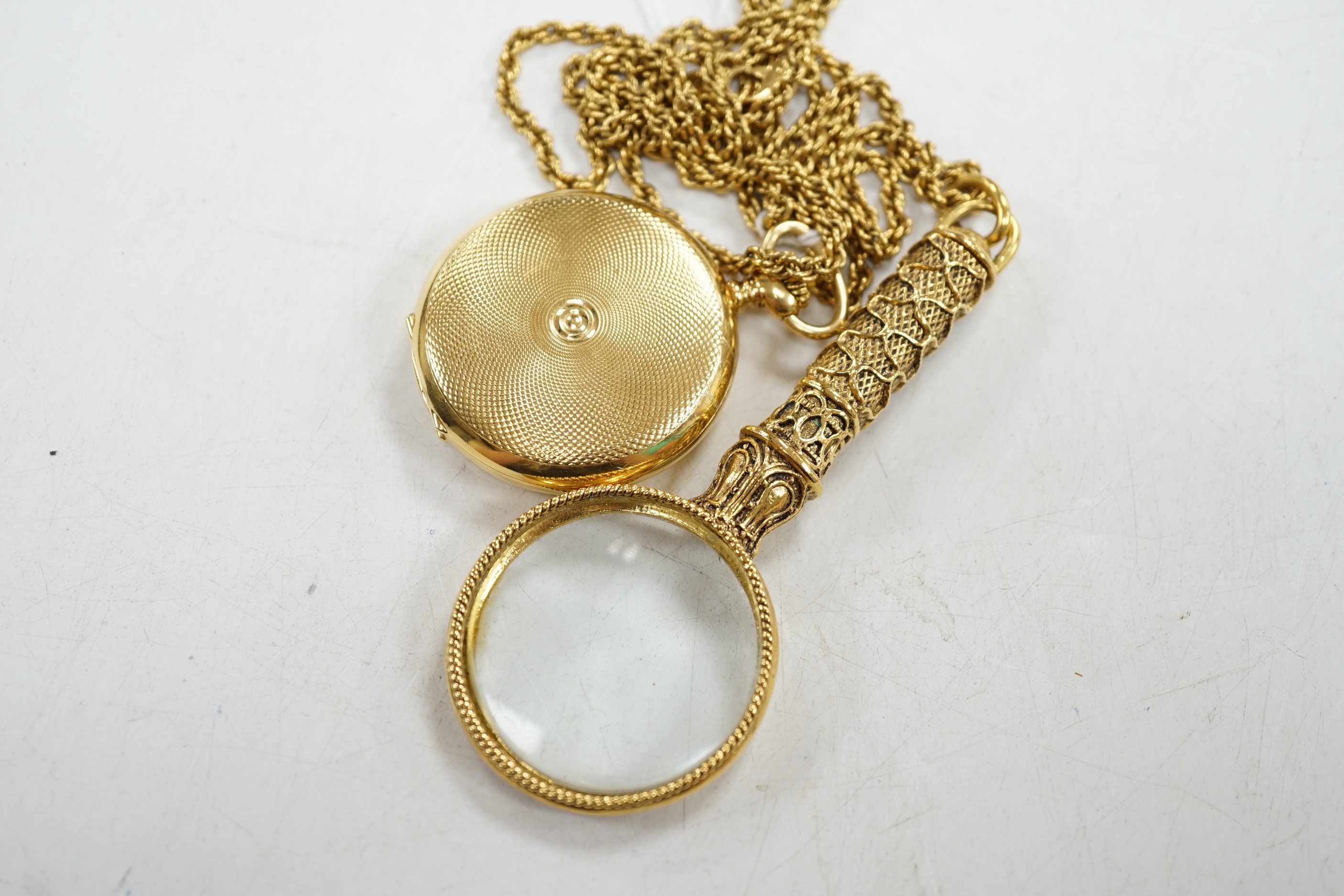 A gold plated Avia keyless pocket watch, on gilt chain with magnifying glass. Condition - fair